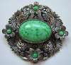 Silver Repousse & Green Glass Brooch